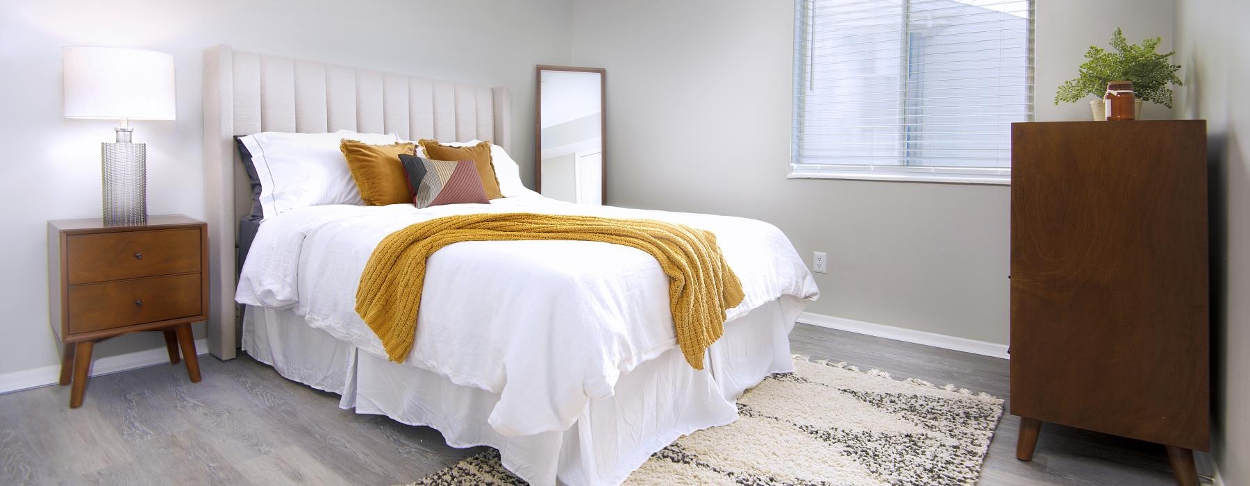 a bedroom with a bed and lamp