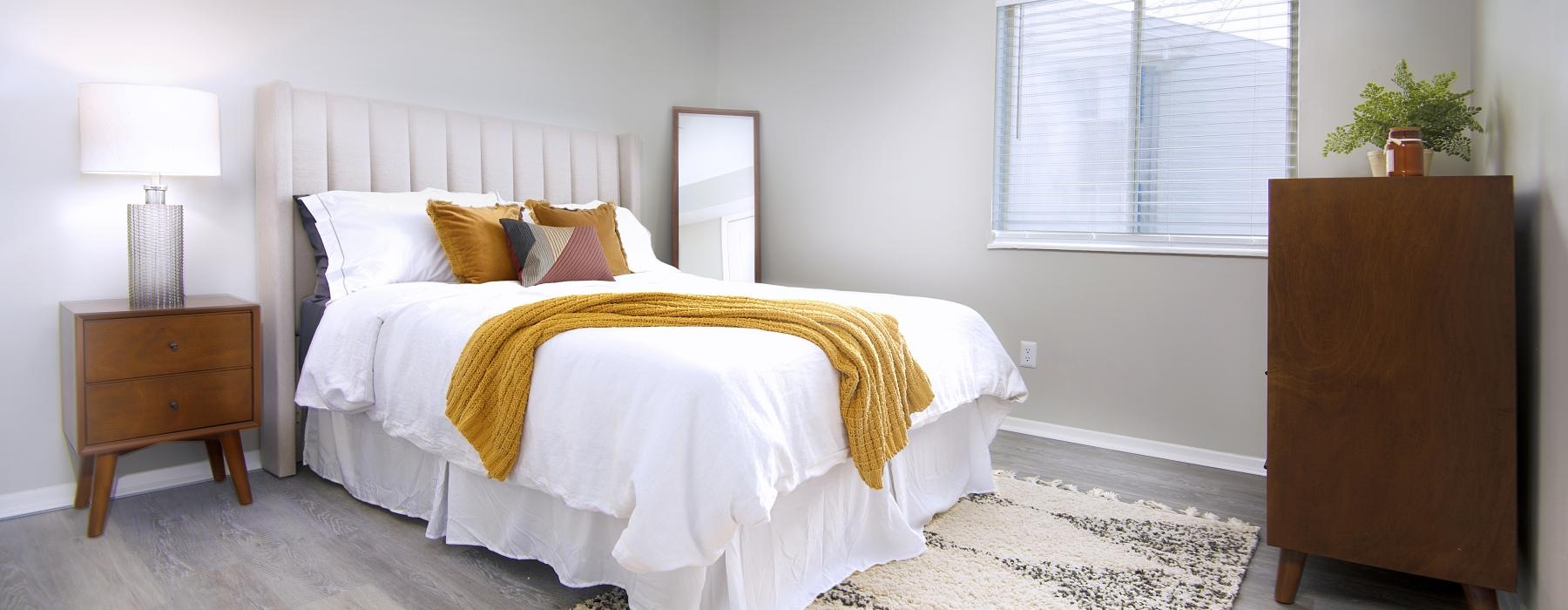 a bedroom with a bed and lamp